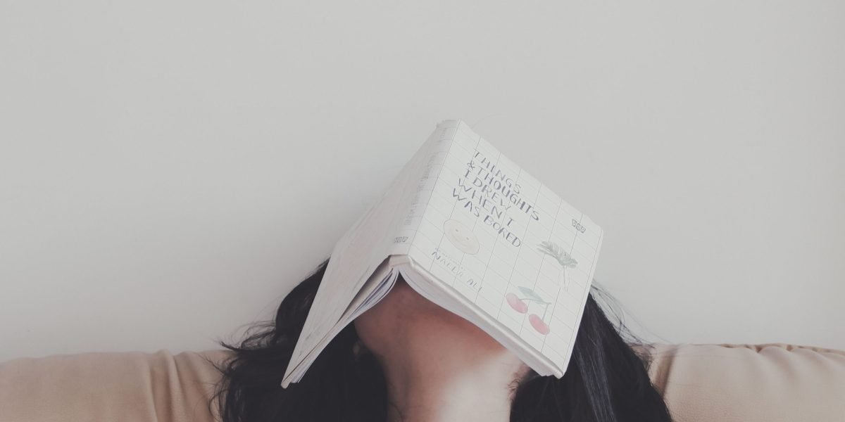 A person deeply engrossed in a book, symbolizing the immersive experience sci-fi adventure novels offer.