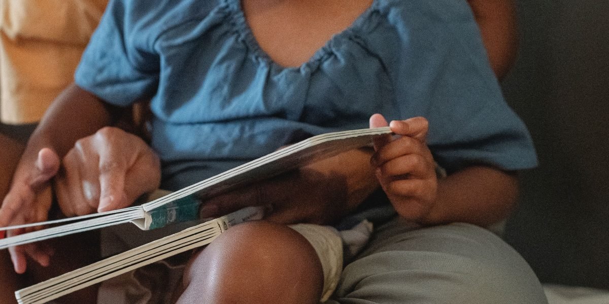 A parent and child enjoy a storybook together, fostering imagination and connection.