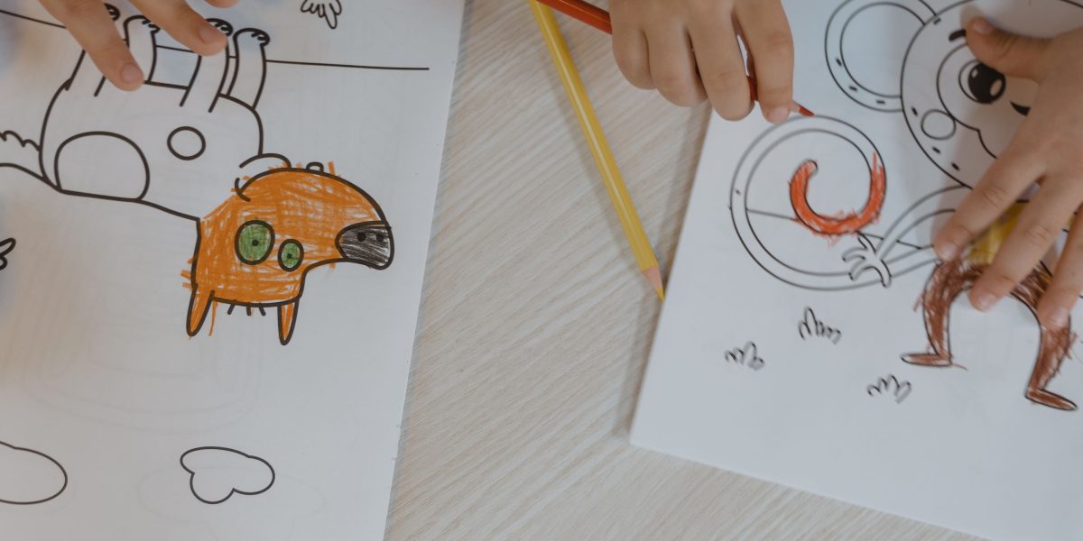 A child fully immersed in a creative activity, drawing and letting their imagination run wild.