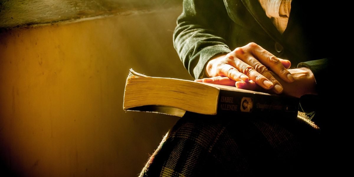 A person intently reading on a tablet, demonstrating a distraction-free digital reading experience.