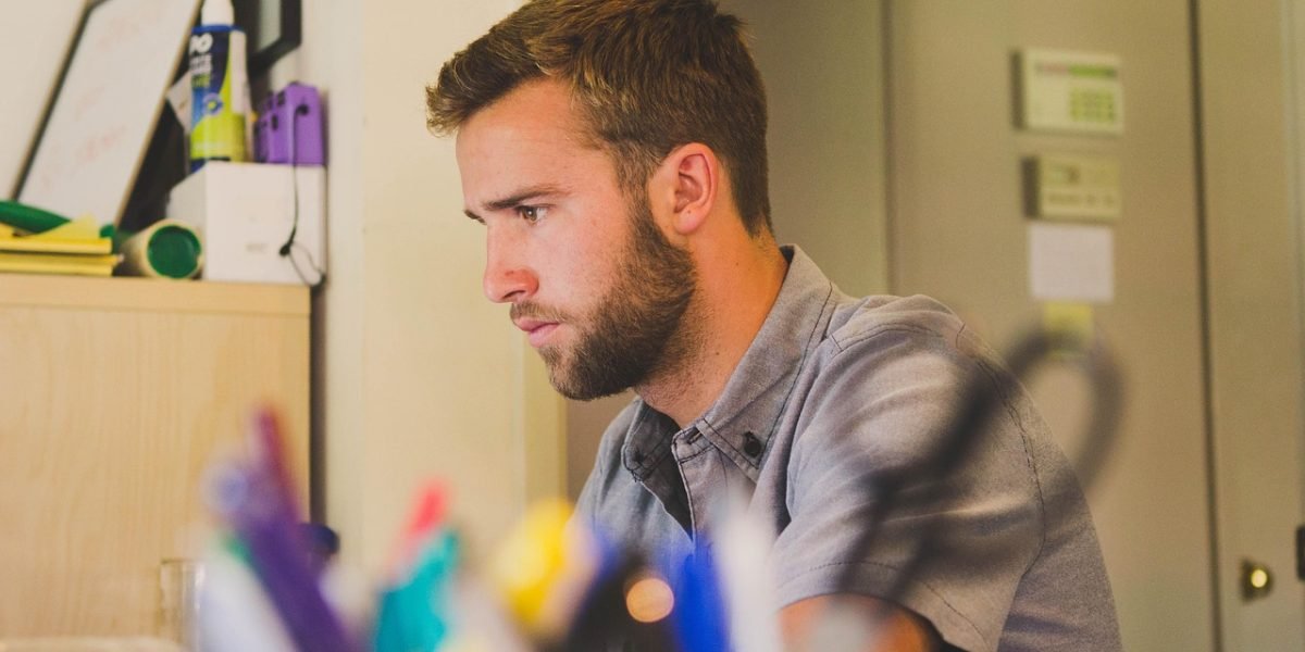A person looking overwhelmed by the constant barrage of digital notifications, symbolizing the modern challenge of digital overload and feeling busy but unproductive.