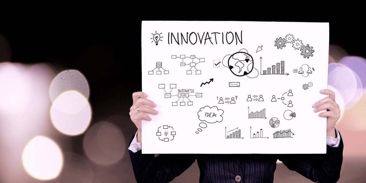 Someone actively planning and strategizing on a whiteboard, illustrating the importance of defining one's unique productivity style before choosing tools.