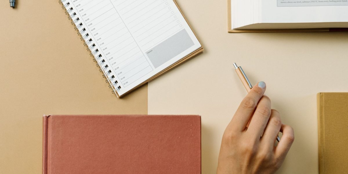 An individual thoughtfully reviewing their week and planning for the next, highlighting the crucial habit of weekly reflection for sustained productivity and mental peace.