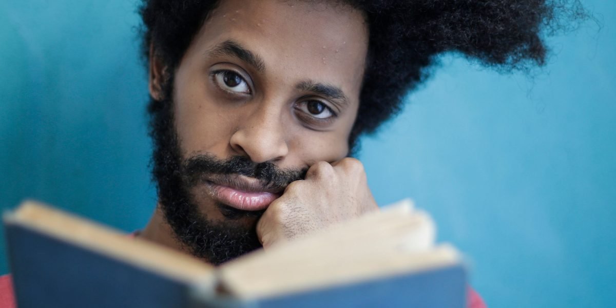 A person engrossed in reading, reflecting on profound ideas presented in a book.