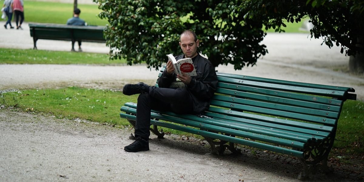 A person deeply engaged in reading a book, finding joy and new ideas.