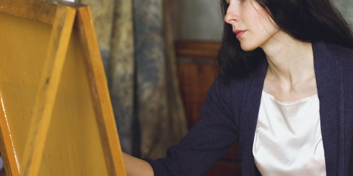 An artist immersed in their creative process, highlighting focus away from technical website building.