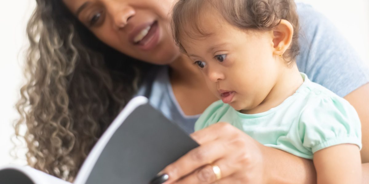 An adult reads a captivating story to a child, illustrating the joy and connection fostered by children's books.