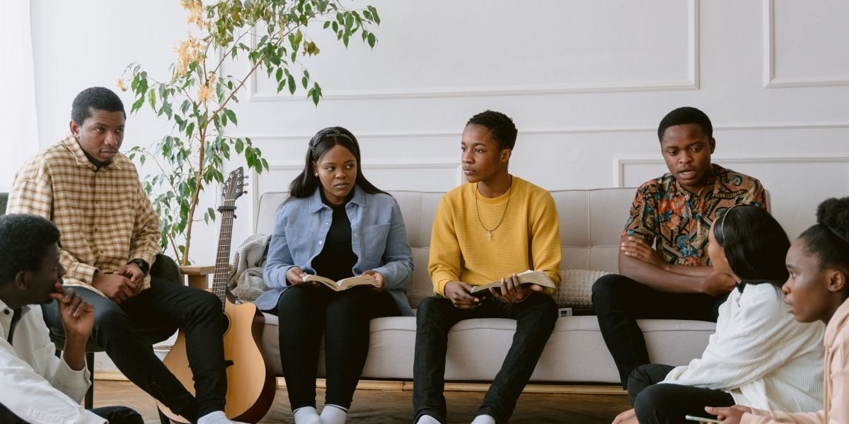 A diverse group of people engaged in a lively discussion, characteristic of a book club meeting.
