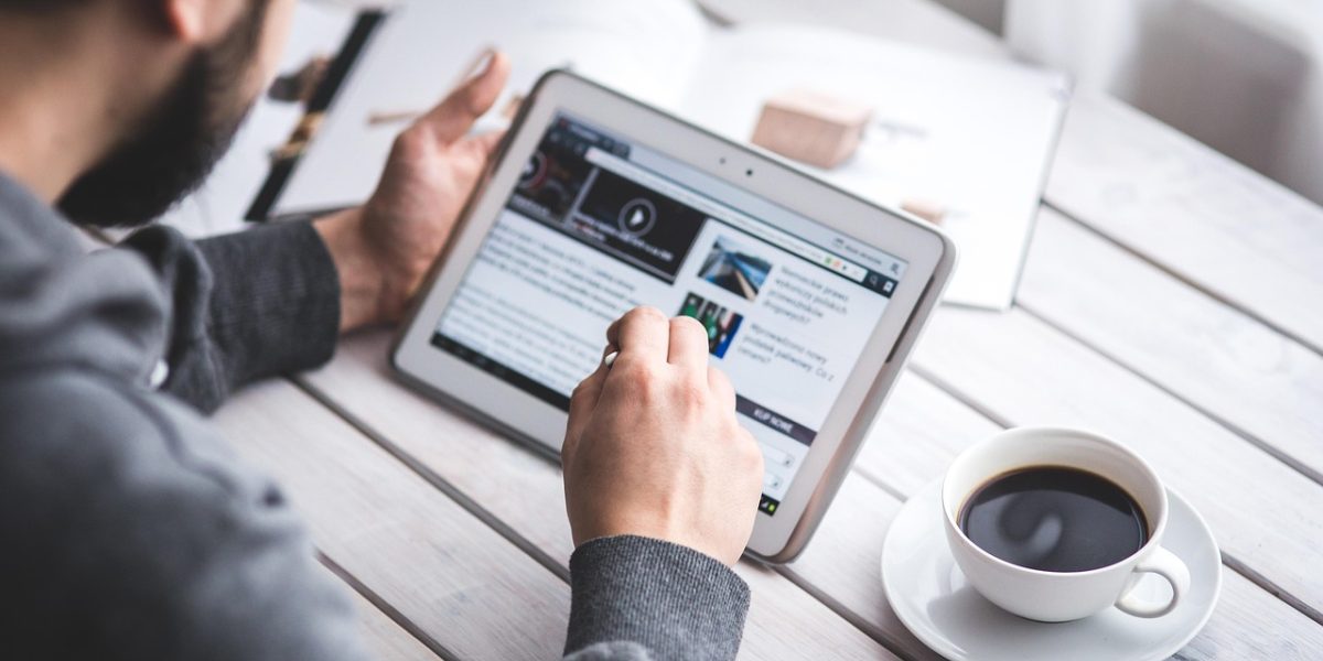 A person seamlessly switching between different devices for a continuous reading experience.
