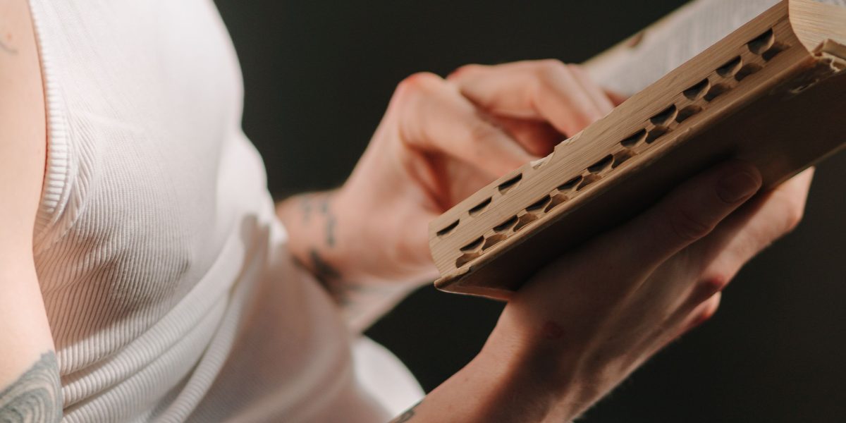 A person deeply engrossed in reading a book, reflecting the 'open book thinking' approach to connect with stories.