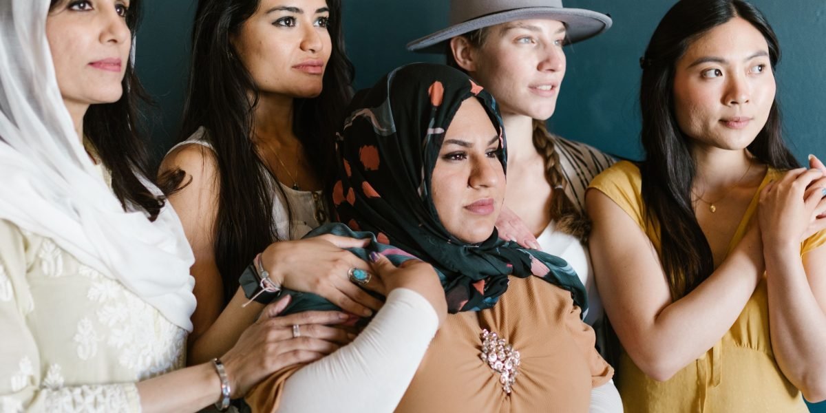 A diverse group of women engaged in supportive conversation, representing the themes of strong women and community in the book.