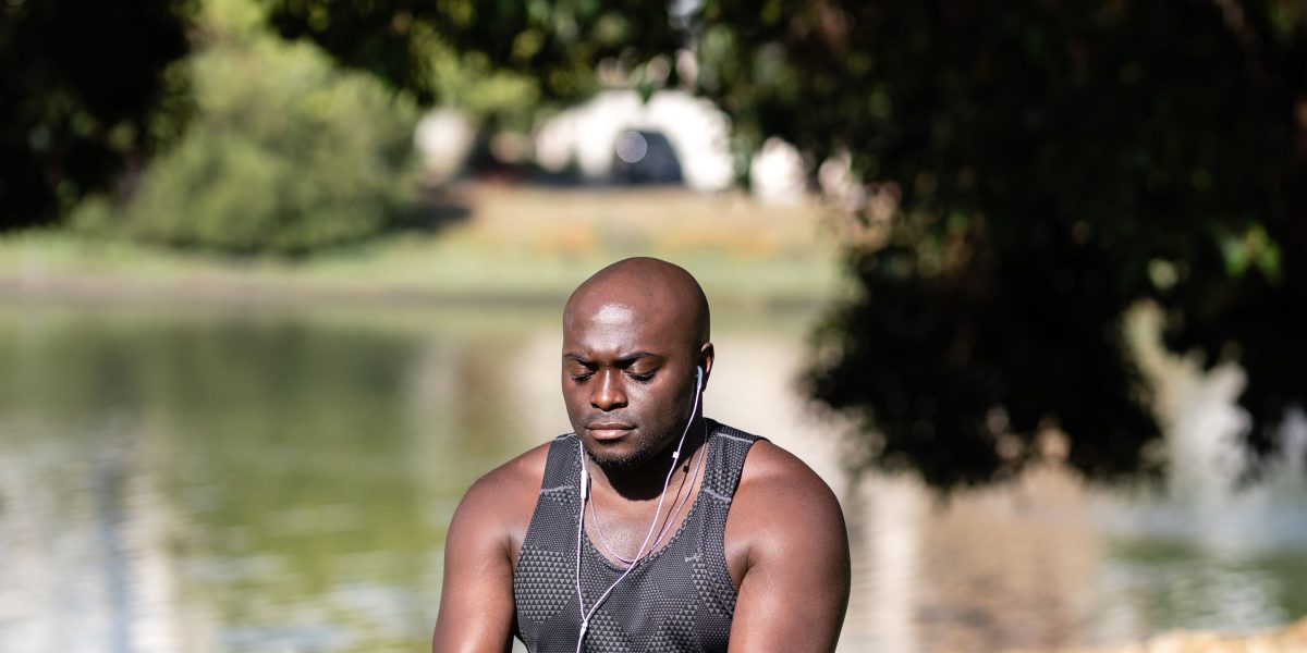A person enjoys an audiobook while walking in a park, illustrating the convenience of audio content.