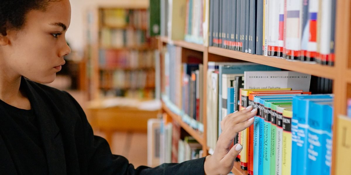 A person joyfully browsing a wide selection of books, embodying the spirit of discovery in reading.