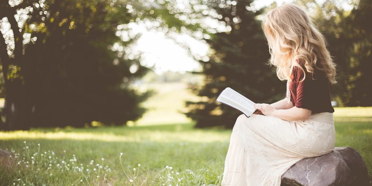 A person engrossed in a book, reflecting on profound ideas, symbolizing personal growth.