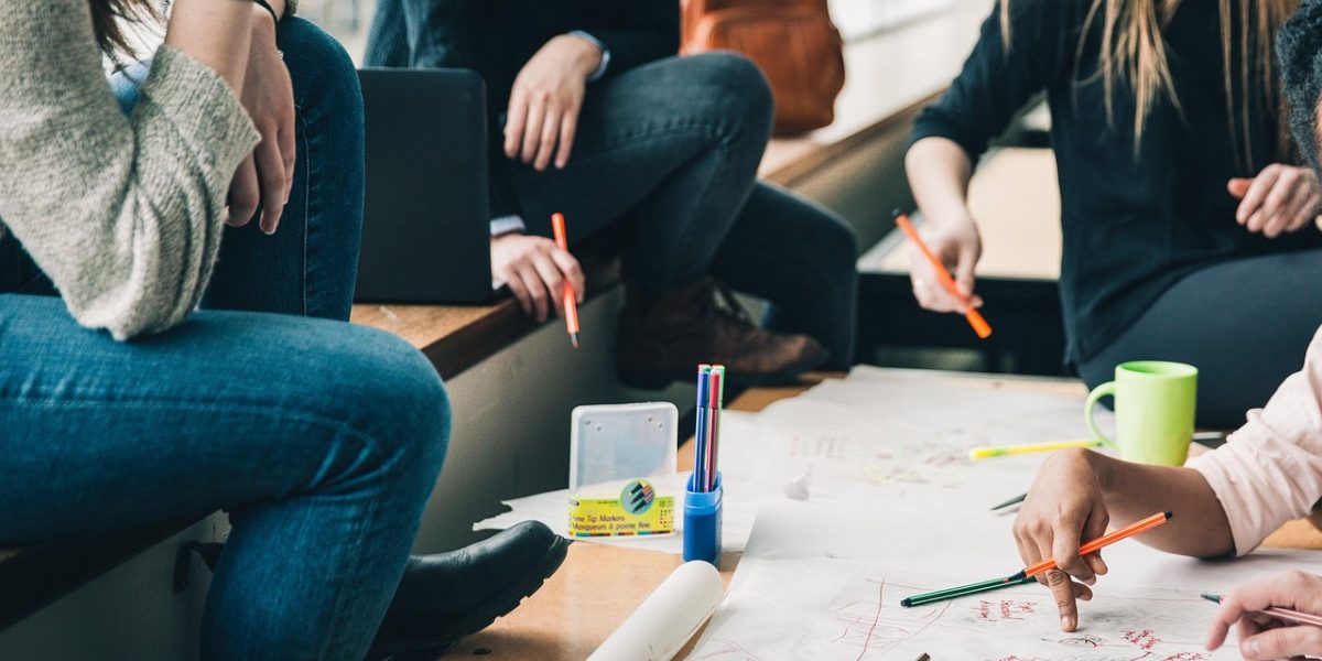 A group of individuals engaged in a lively discussion, sharing insights and connecting over complex topics.