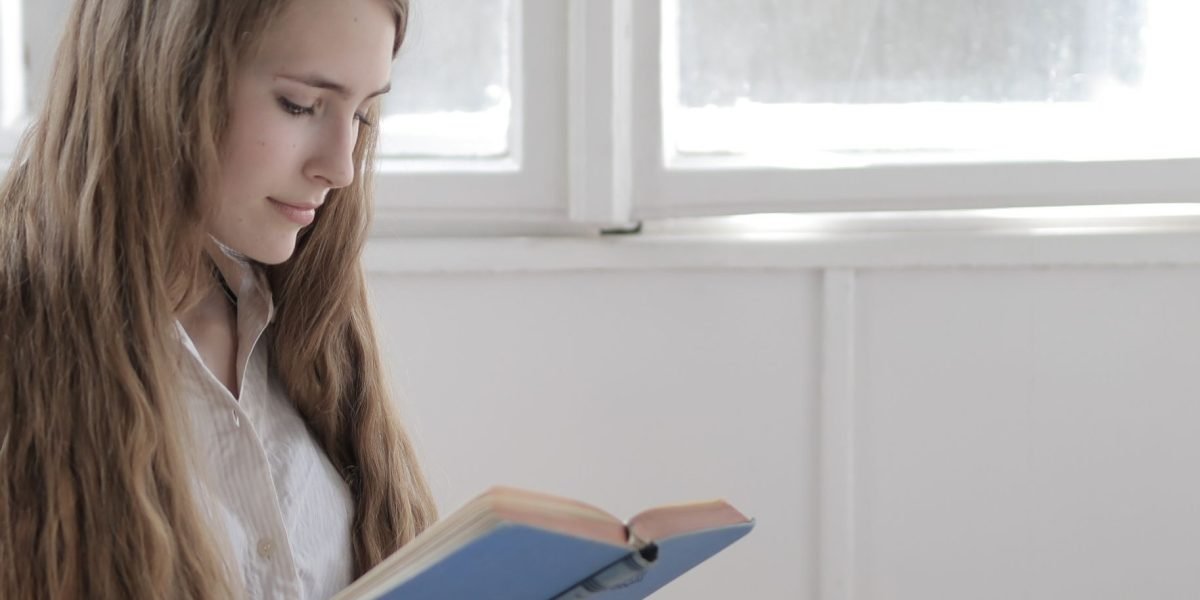 A person finding solace and connection through reading, embodying the comforting power of books.