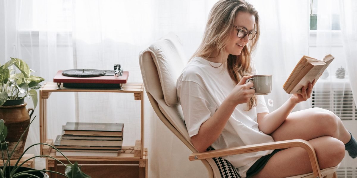 A person enjoys reading a book, symbolizing the desire for affordable access to literature.