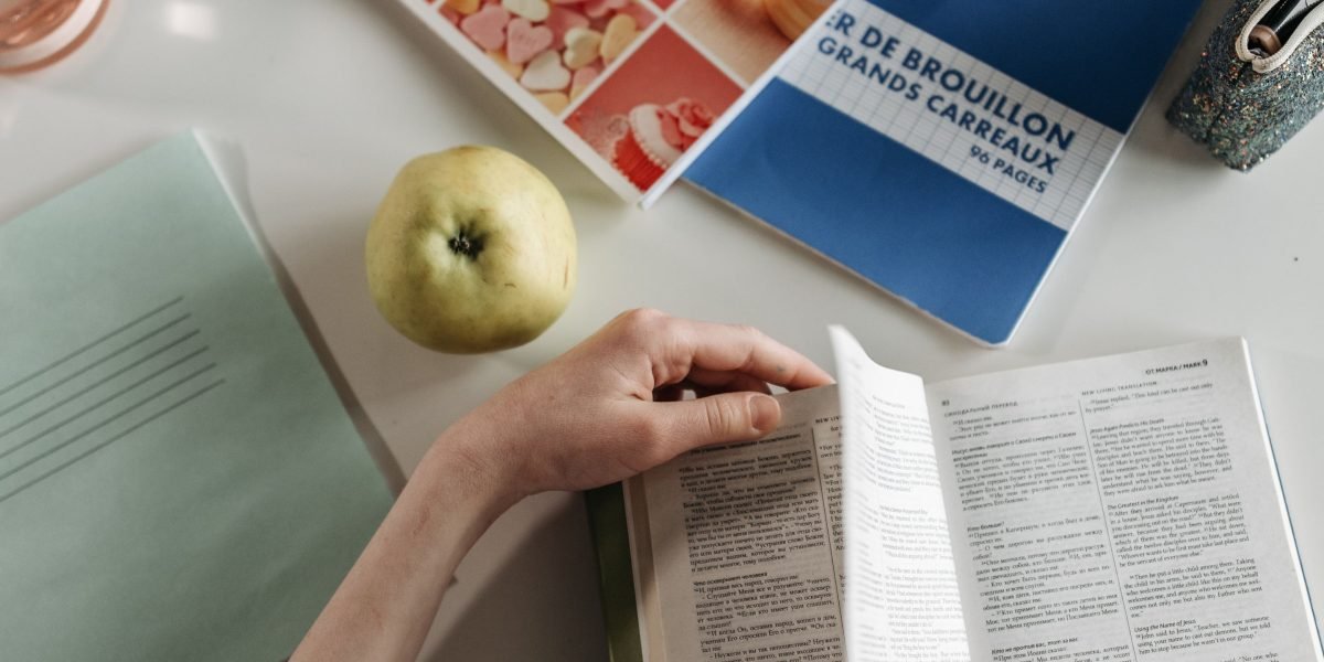 A person carefully examines a book, emphasizing the importance of checking condition and trusting sellers.