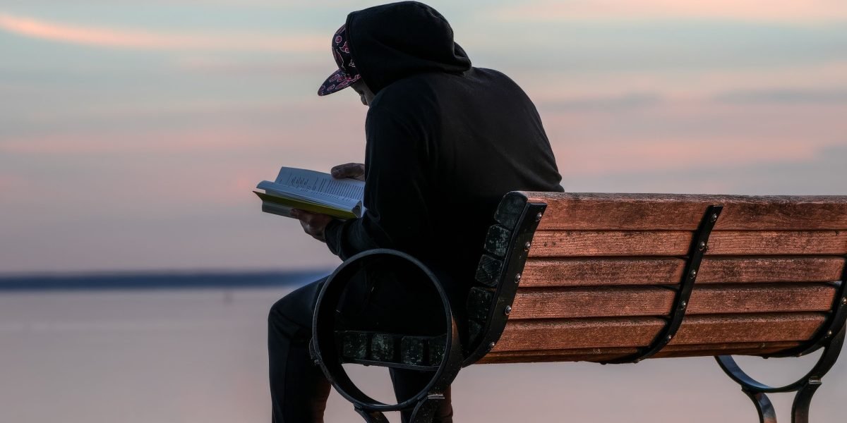 A person in a peaceful setting, taking a moment to reflect and find deeper meaning in life.