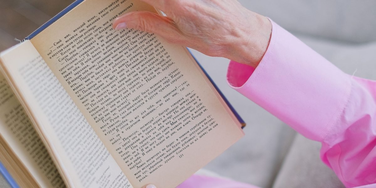 A person deeply immersed in a book, highlighting the power of stories to transport and transform.