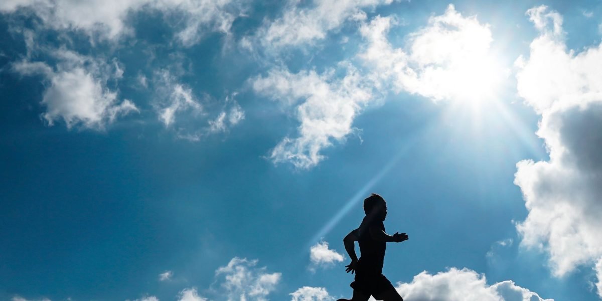 A person feeling motivated and joyful during an outdoor run, embodying the spirit of a rewarding fitness journey.