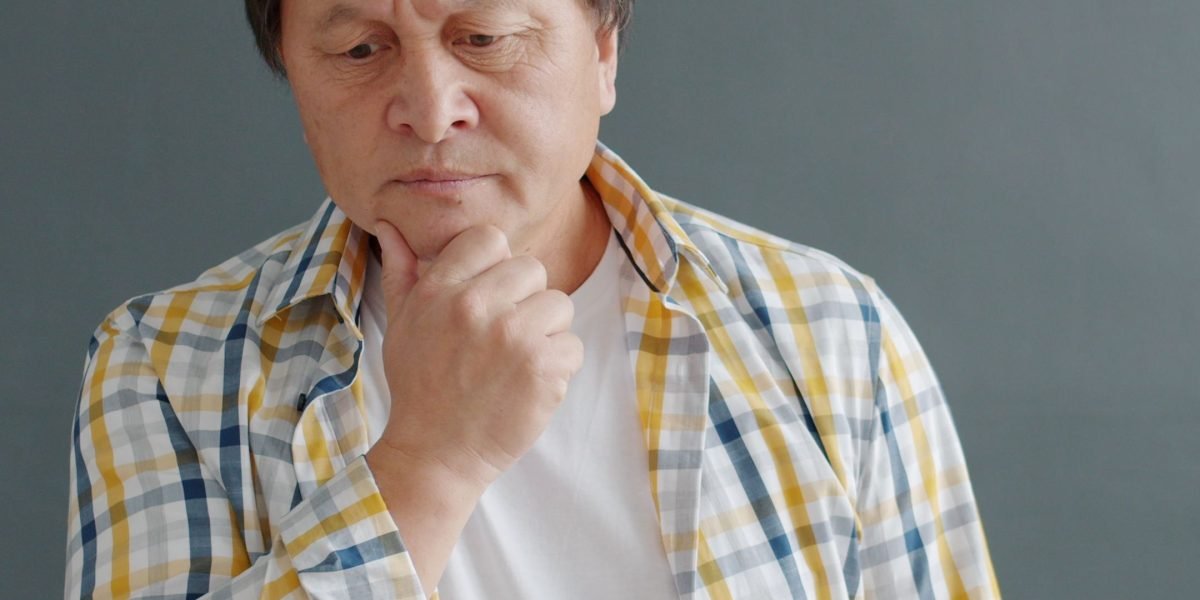 A thoughtful person at a desk, reviewing different options on paper, illustrating the process of making an informed decision.