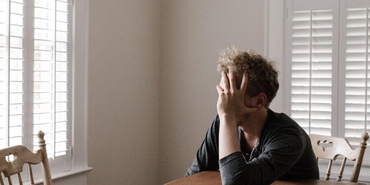 A person reflects on daily pressures, highlighting the common experience of stress and worry in modern life.