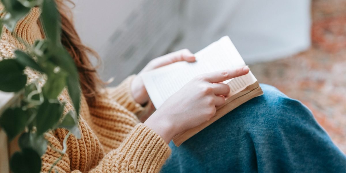 A person finding peace and escape in a good book, highlighting the joy and well-being from reading.
