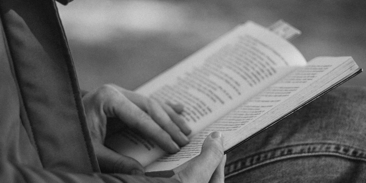 An individual thoughtfully integrating reading into their daily life, illustrating the development of a gentle and consistent habit.