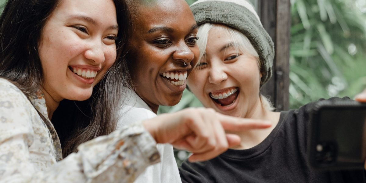 A group of diverse friends laughing and enjoying a shared experience, reflecting community connection.